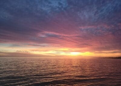 A breathtaking and romantic evening sunset view from a private six-passenger pontoon tour cruising the waters of the Emerald Coast.