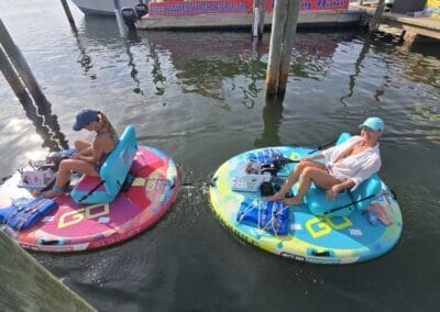 Aerial view of two friends riding motorized float boats next to the docks at Sabine Marina in Pensacola.