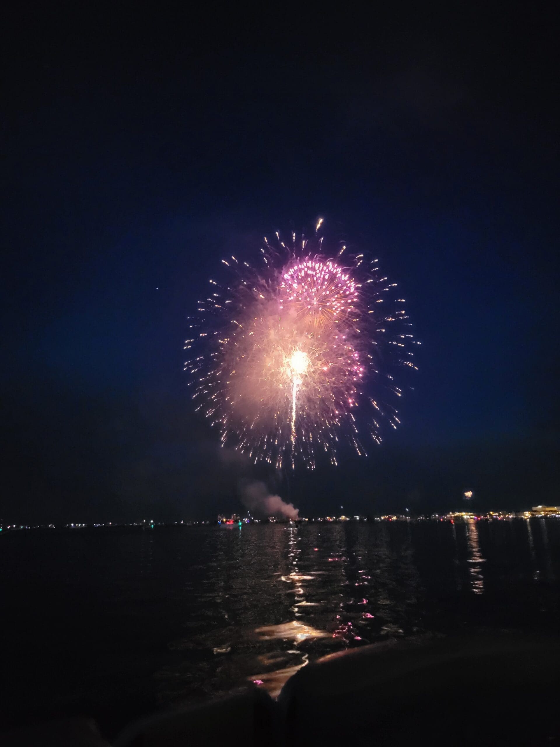 Watching the 4th of July fireworks over the water from a luxury tritoon in Pensacola.